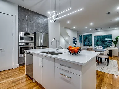 Addison open plan kitchen with living area and island with sink in full home renovation