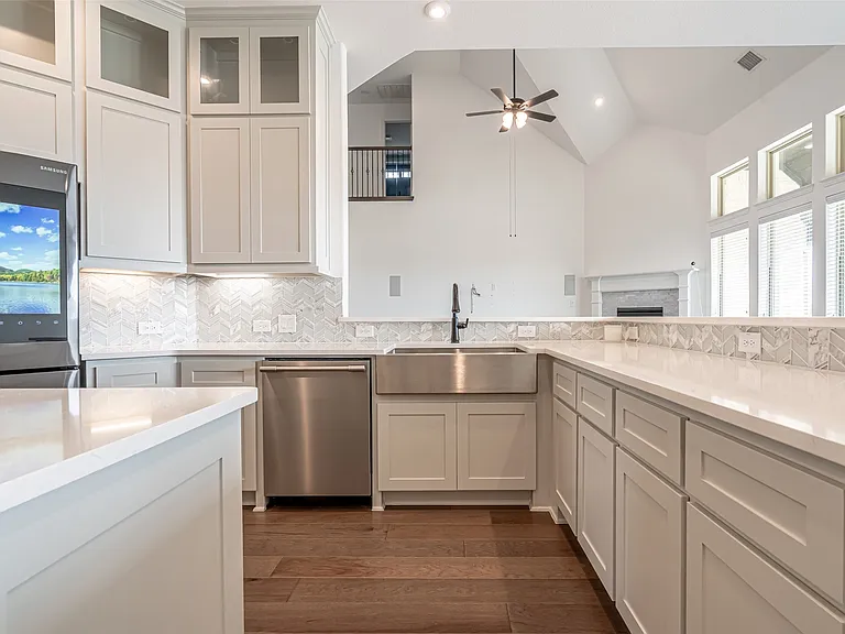 White kitchen remodel with chevron backsplash and farmhouse sink in Allen TX by UHS Remodeling