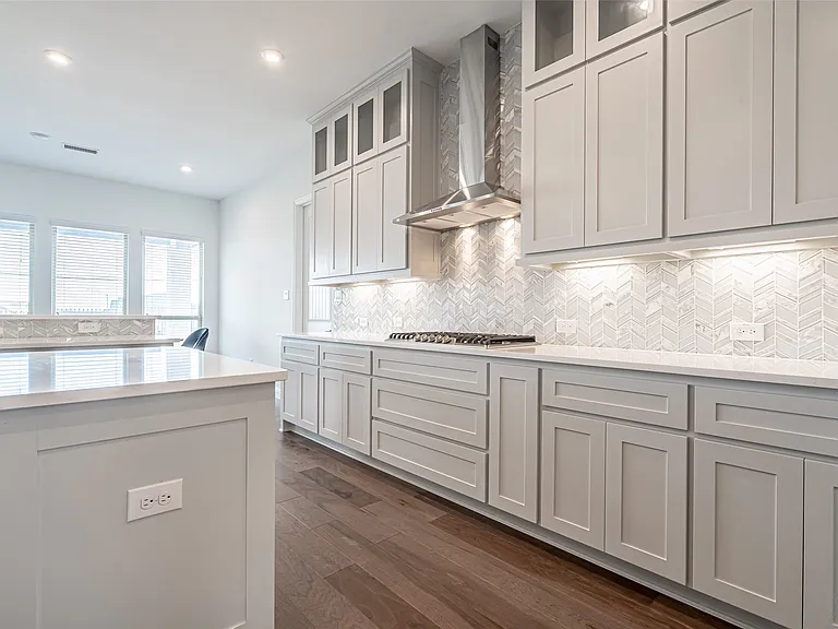 Kitchen remodel with stainless hood and chevron tile backsplash in Allen TX by UHS Remodeling