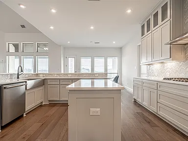 Affordable white kitchen remodel with center island and quartz counters in Allen TX by UHS Remodeling