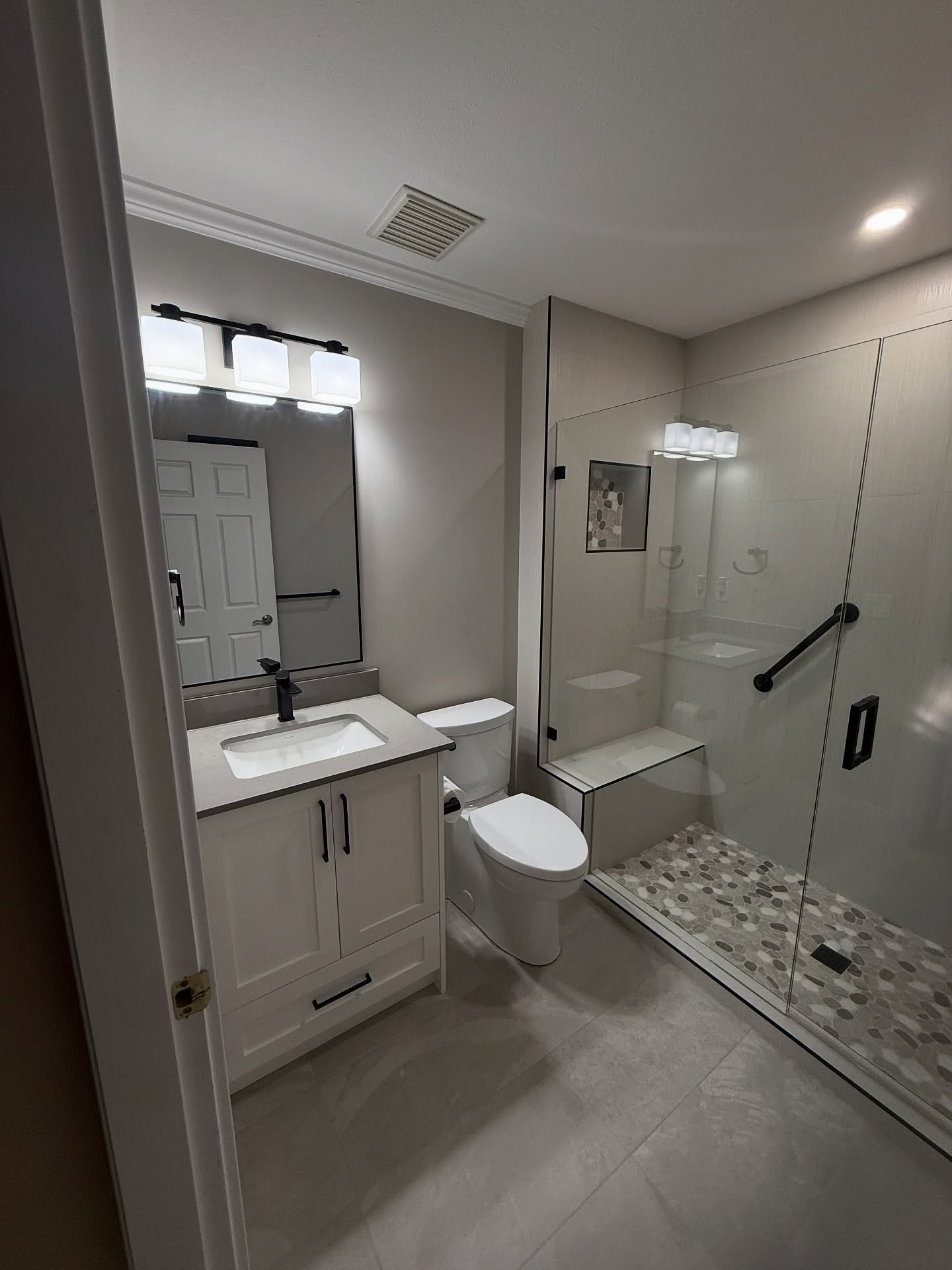 Dallas TX bathroom remodel with white shaker vanity and walk-in shower