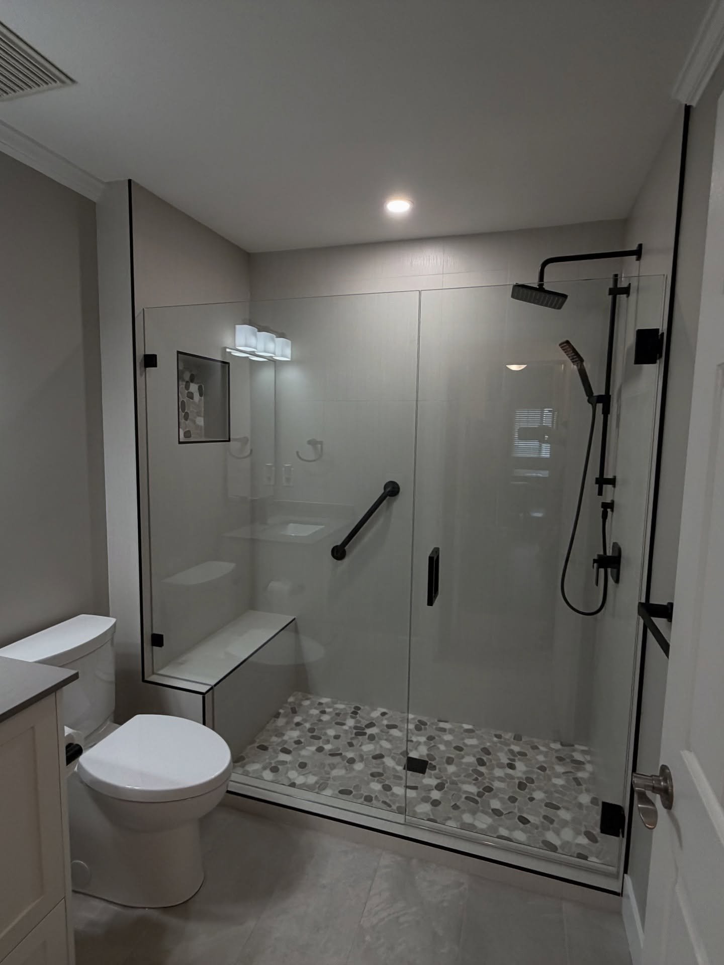 Dallas TX bathroom remodel with frameless glass shower and matte black fixtures