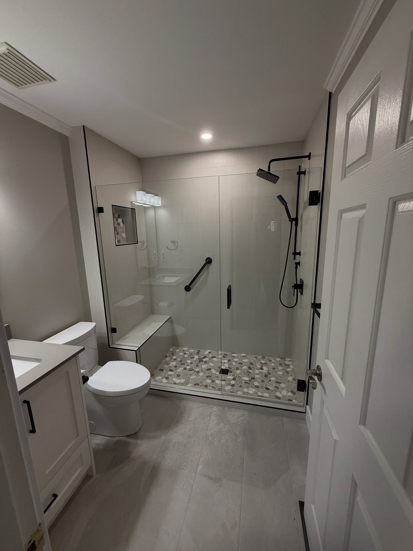 Dallas TX bathroom remodel with walk-in shower and pebble mosaic floor
