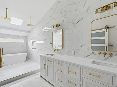 Luxury bathroom with gold fixtures and freestanding tub in Richardson TX home by UHS Remodeling