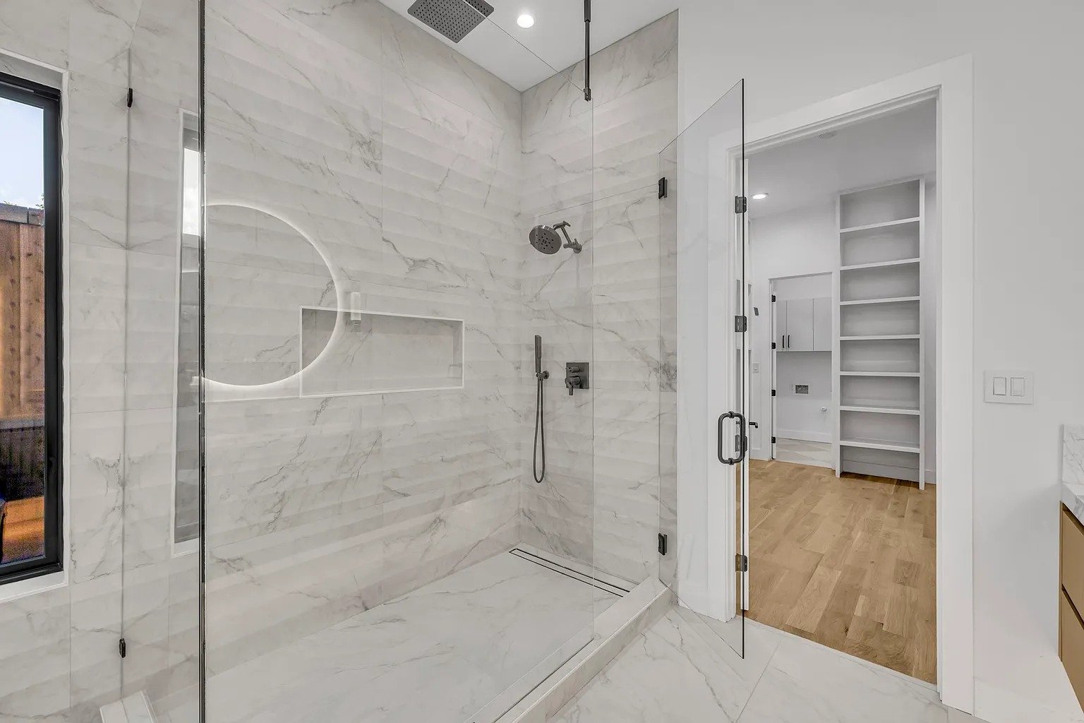 Marble walk-in glass shower in master bathroom remodel Dallas TX by UHS Remodeling