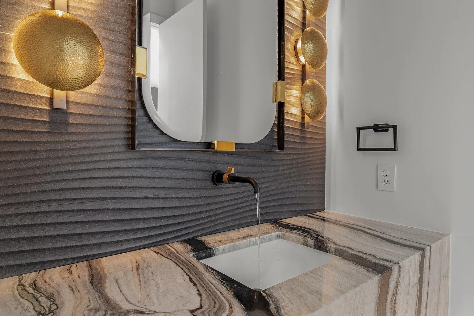 Powder room with onyx counter and gold sconces in full home remodel Dallas TX by UHS Remodeling