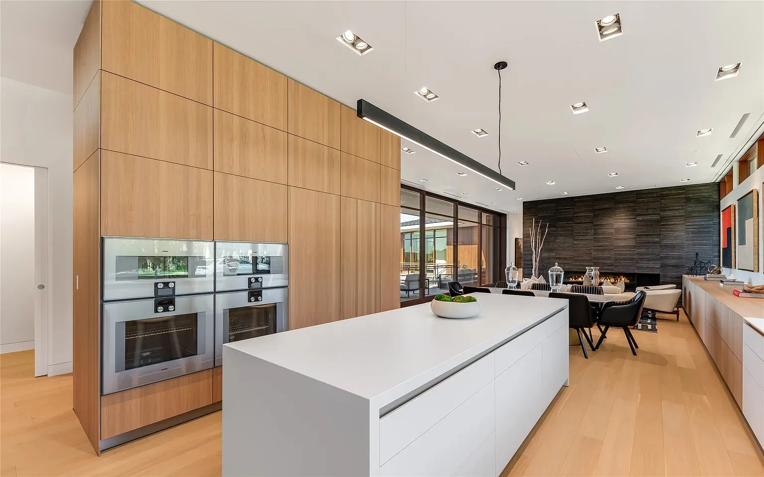 Modern luxury kitchen with walnut cabinets and double wall ovens in Dallas TX