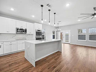 Full home renovation in Farmers Branch TX with open-concept kitchen and island by UHS Remodeling