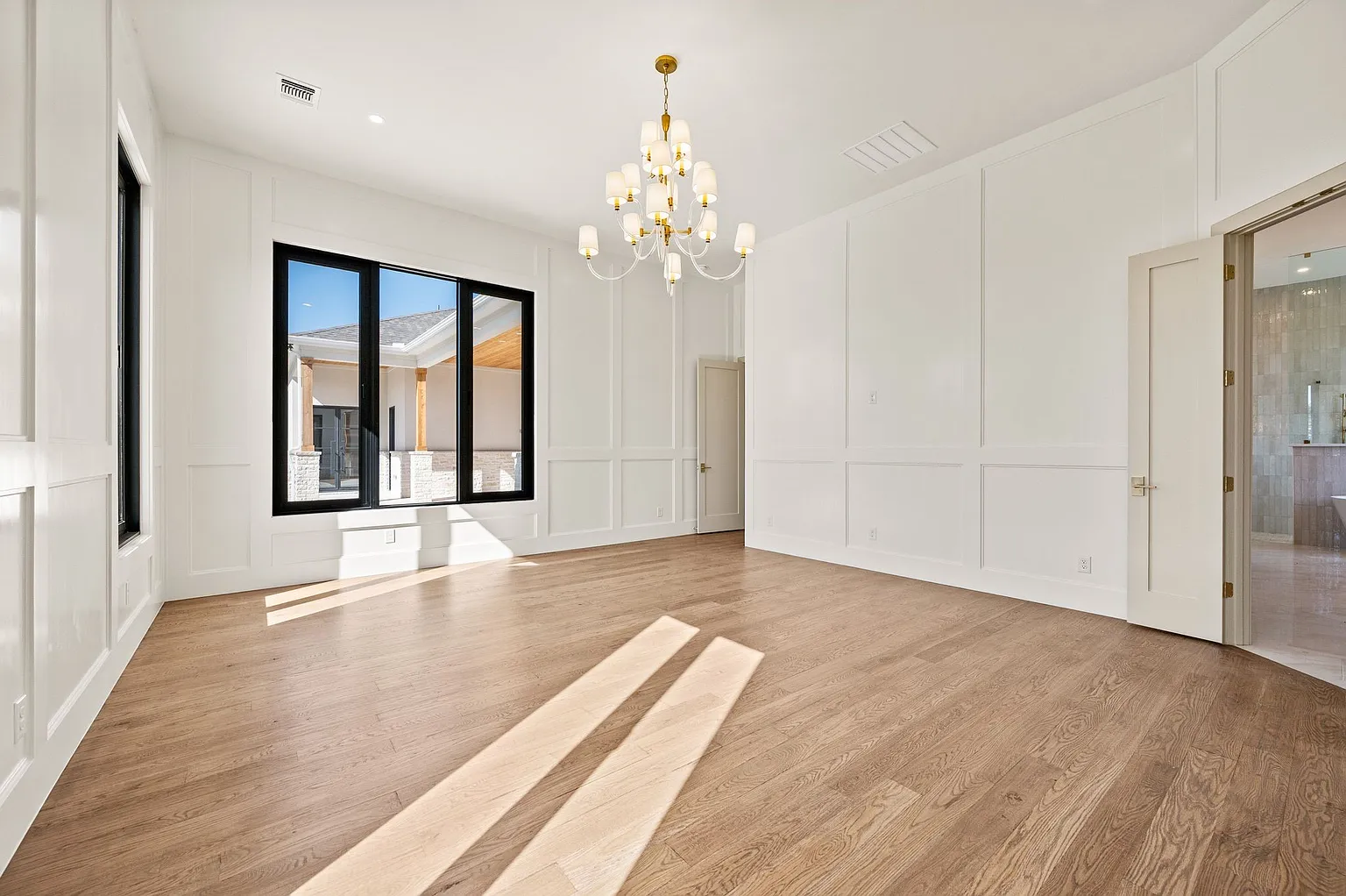 Formal dining room with wainscoting and crystal chandelier in full home renovation Frisco TX by UHS Remodeling