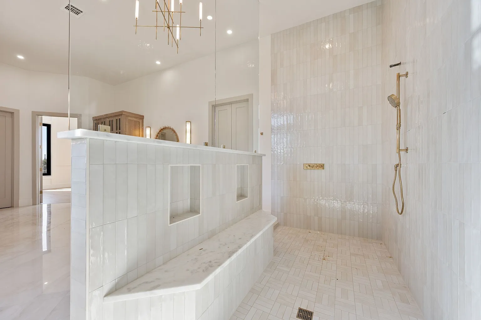 Luxury walk-in shower with marble bench and chandelier in full home renovation Frisco TX by UHS Remodeling