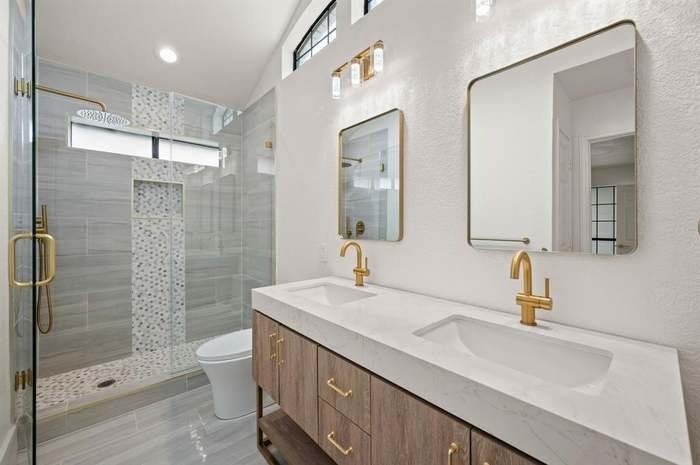Dallas TX bathroom with double vanity and gold faucets