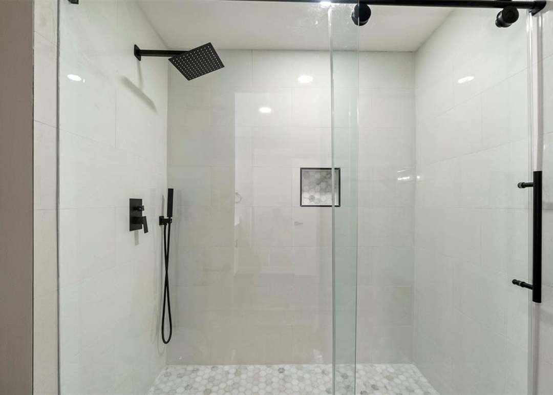 Walk-in shower with large white tile Dallas TX