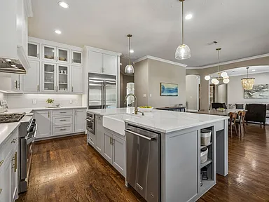 Garland TX kitchen remodel with island and glass-front upper cabinets by UHS Remodeling