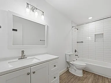 Guest bathroom remodel in Garland TX with LED mirror and white stacked subway tile
