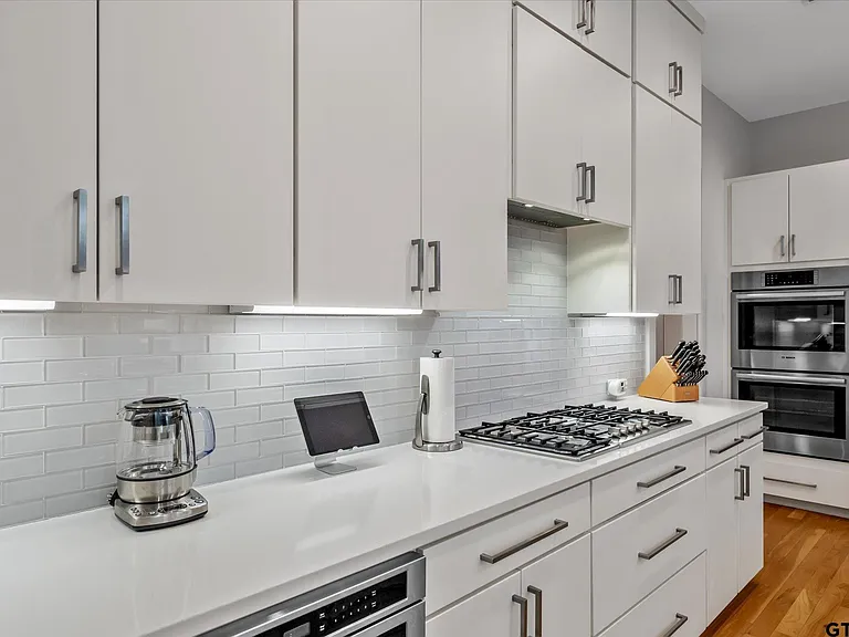 Highland Park kitchen with subway tile backsplash gas cooktop and double wall ovens by UHS Remodeling