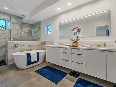 Luxury master bathroom remodel with freestanding tub and double vanity in Highland Park TX by UHS Remodeling