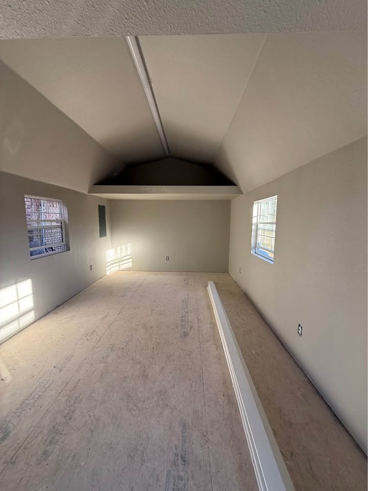 Plano TX home addition framed interior with vaulted ceiling and new windows ready for finish
