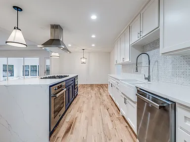 Kitchen renovation in Richardson TX with white cabinets and quartz countertops by UHS Remodeling