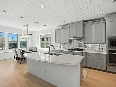 Kitchen full view curved island chandelier Little Elm TX