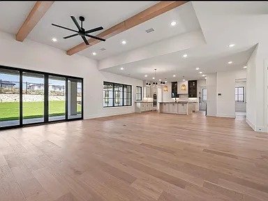 Open plan living and kitchen home addition with exposed beams in Plano TX by UHS Remodeling