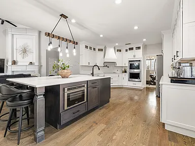 Kitchen island with microwave drawer in open plan Plano TX home