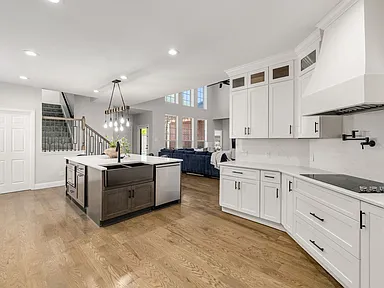 Custom range hood with pot filler and double wall oven in Plano TX kitchen