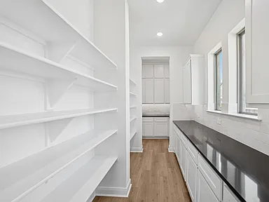 Butler pantry with open shelving and marble backsplash in Rockwall TX by UHS Remodeling