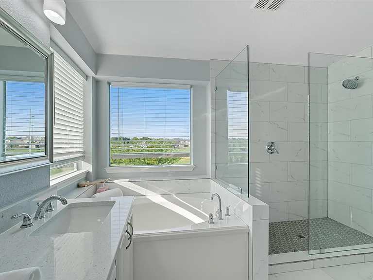 Master bathroom remodel in Sachse TX with freestanding tub and glass shower by UHS Remodeling