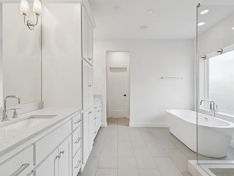 Master bathroom remodel in University Park TX with freestanding tub and glass shower by UHS Remodeling