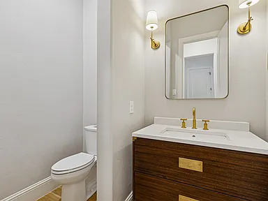 Warm powder room wood vanity gold fixtures University Park TX