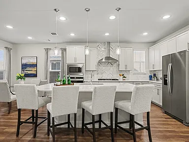 Kitchen with large island and four barstools in Wylie TX home remodel by UHS Remodeling