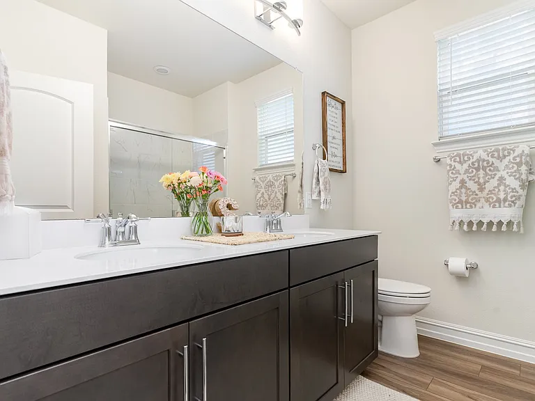 Master bathroom remodel in Wylie TX with espresso double vanity and chrome lighting by UHS Remodeling