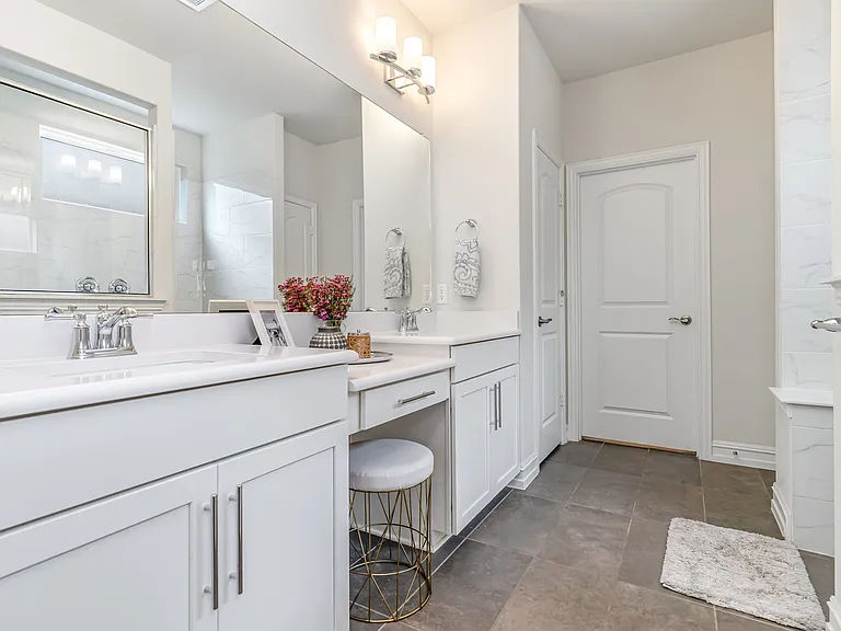 Master bathroom with white vanity makeup area and marble shower in Wylie TX by UHS Remodeling
