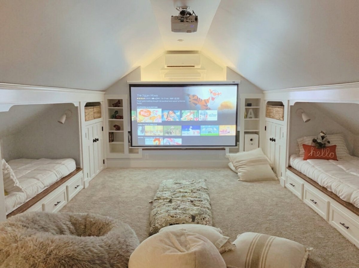 Finished attic media and playroom with built-in bunk beds and a projector by UHS Remodeling in Dallas-Fort Worth