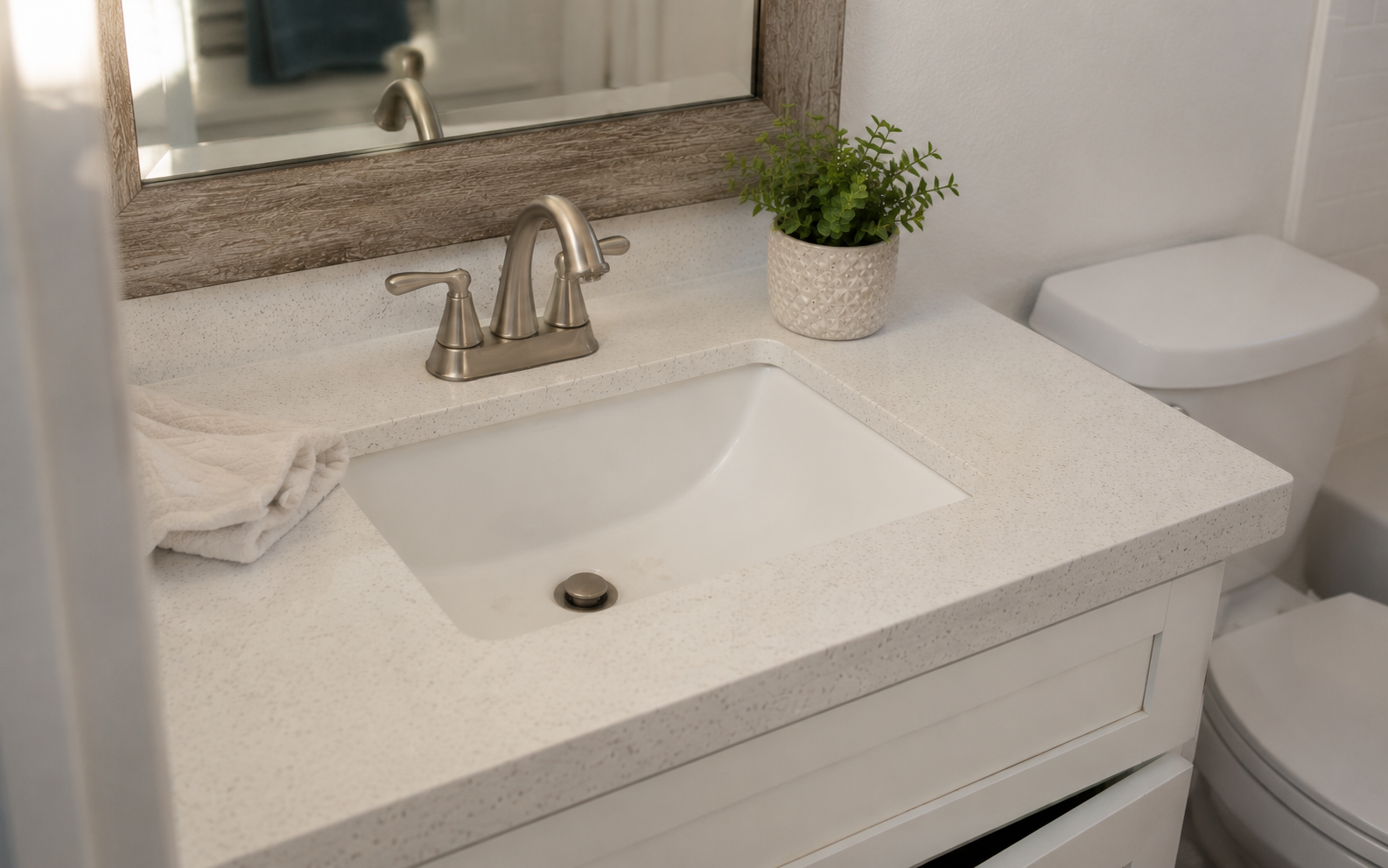 Prefab vanity with quartz-look top in a Plano hall bath by UHS Remodeling
