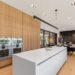 Flat-panel white oak kitchen cabinets with integrated double ovens in a Dallas luxury kitchen