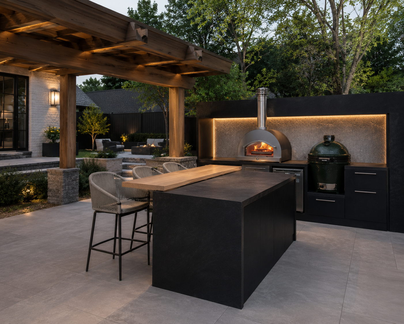 Covered patio outdoor kitchen with a wood pergola, a pizza oven, and bar seating at dusk