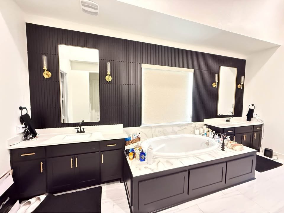 Primary bathroom with a fluted accent wall and double vanity in a Plano, TX interior remodel by UHS Remodeling