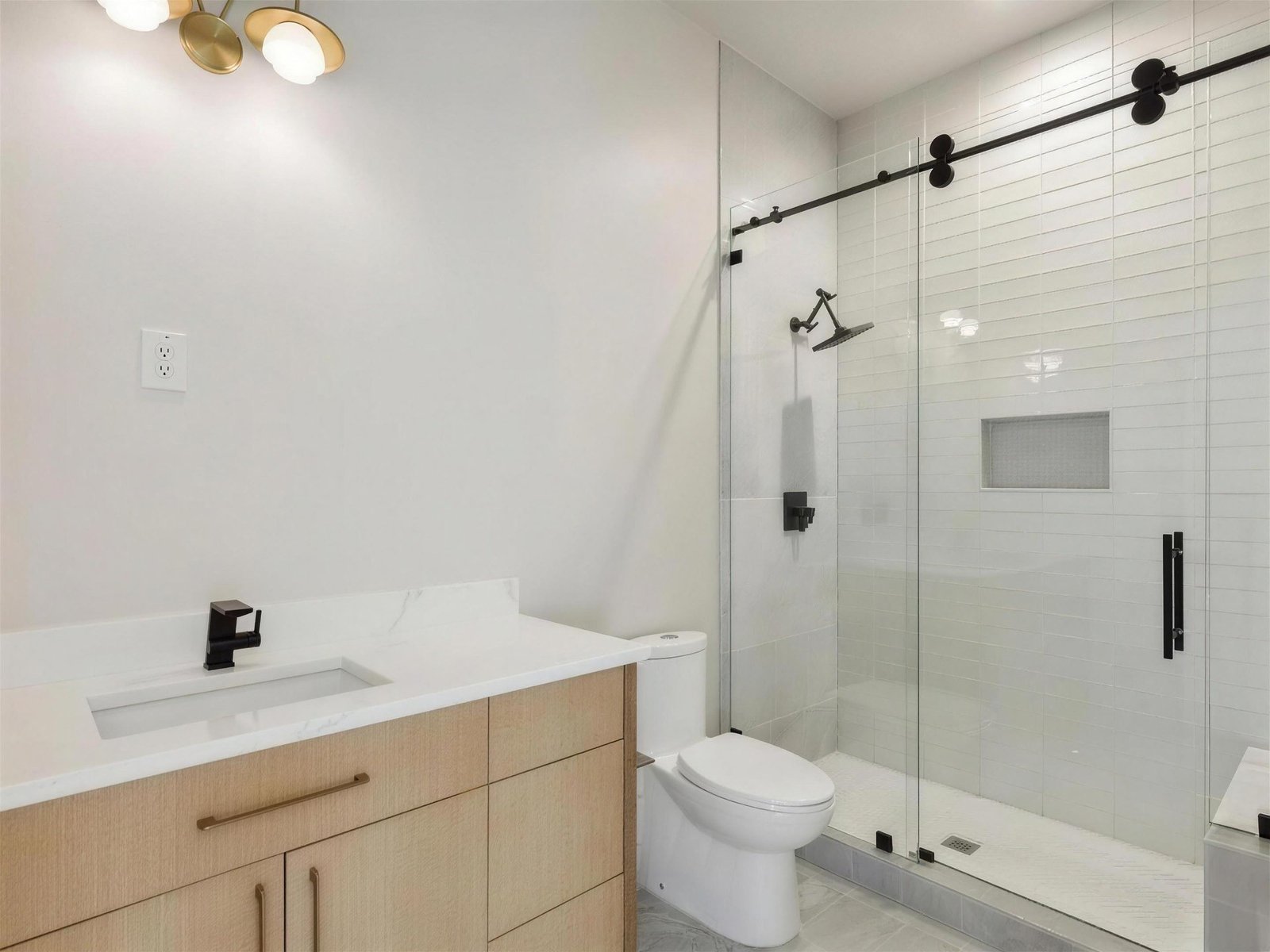 Bathroom remodel in The Colony, TX — black frame sliding shower — UHS Remodeling project