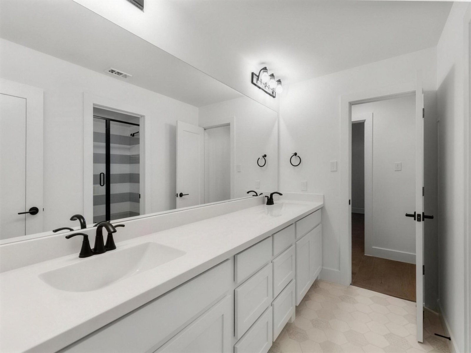 Bathroom remodel in Allen, TX — double vanity black faucets — UHS Remodeling project