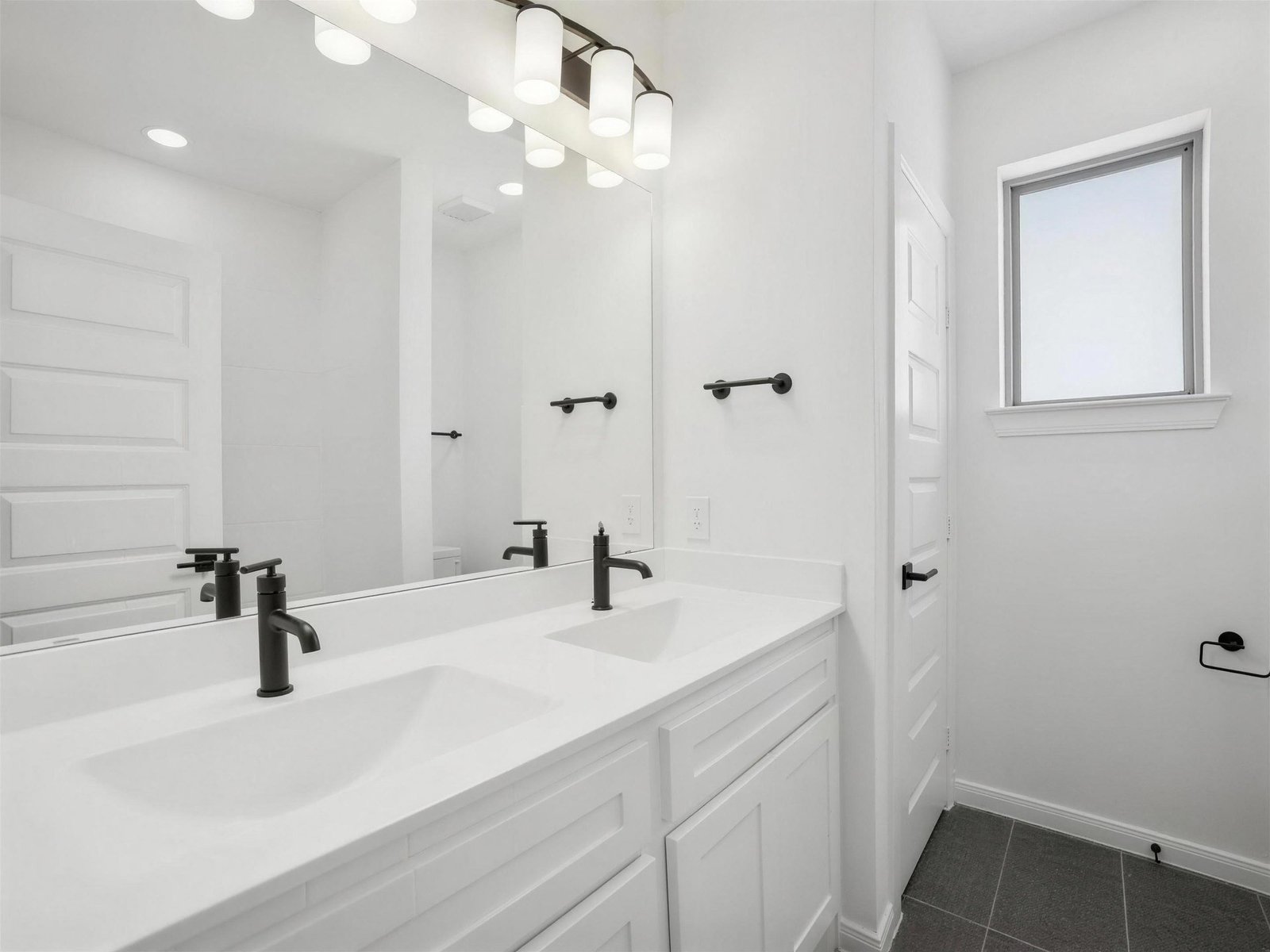 Bathroom remodel in Rockwall, TX — double vanity black faucets — UHS Remodeling project