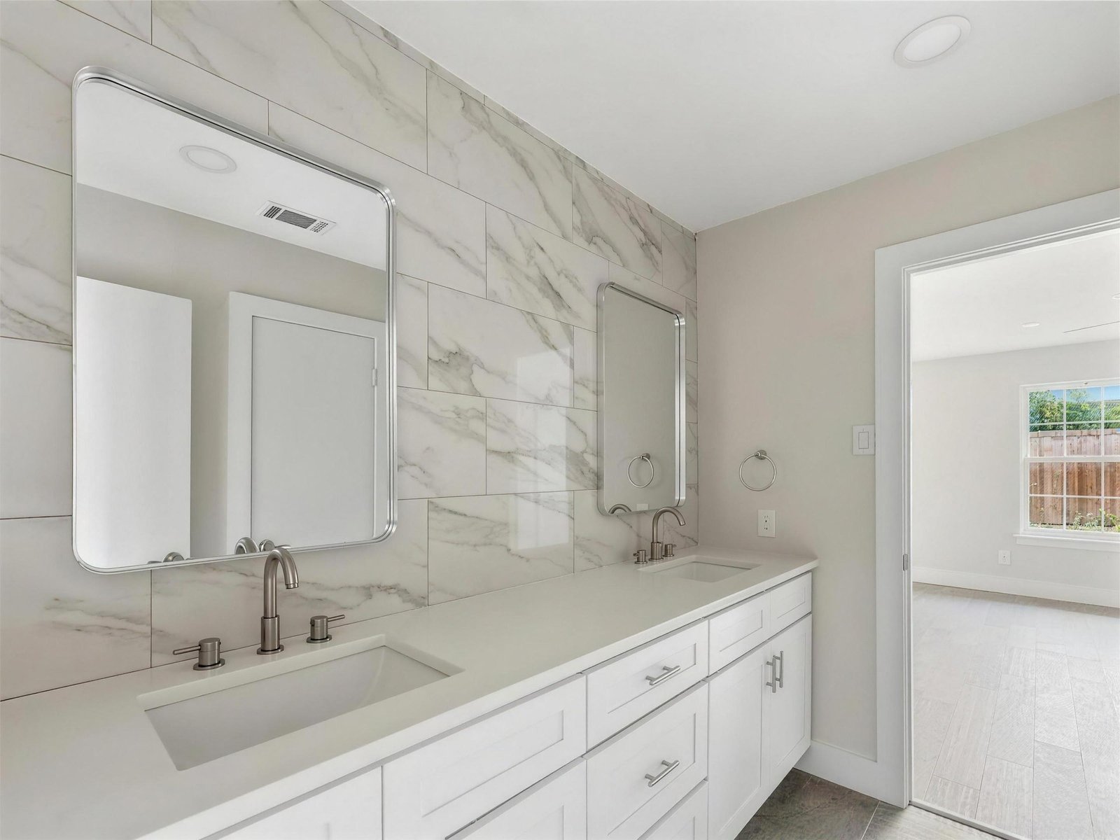 Bathroom remodel in Richardson, TX — double vanity marble tile — UHS Remodeling project