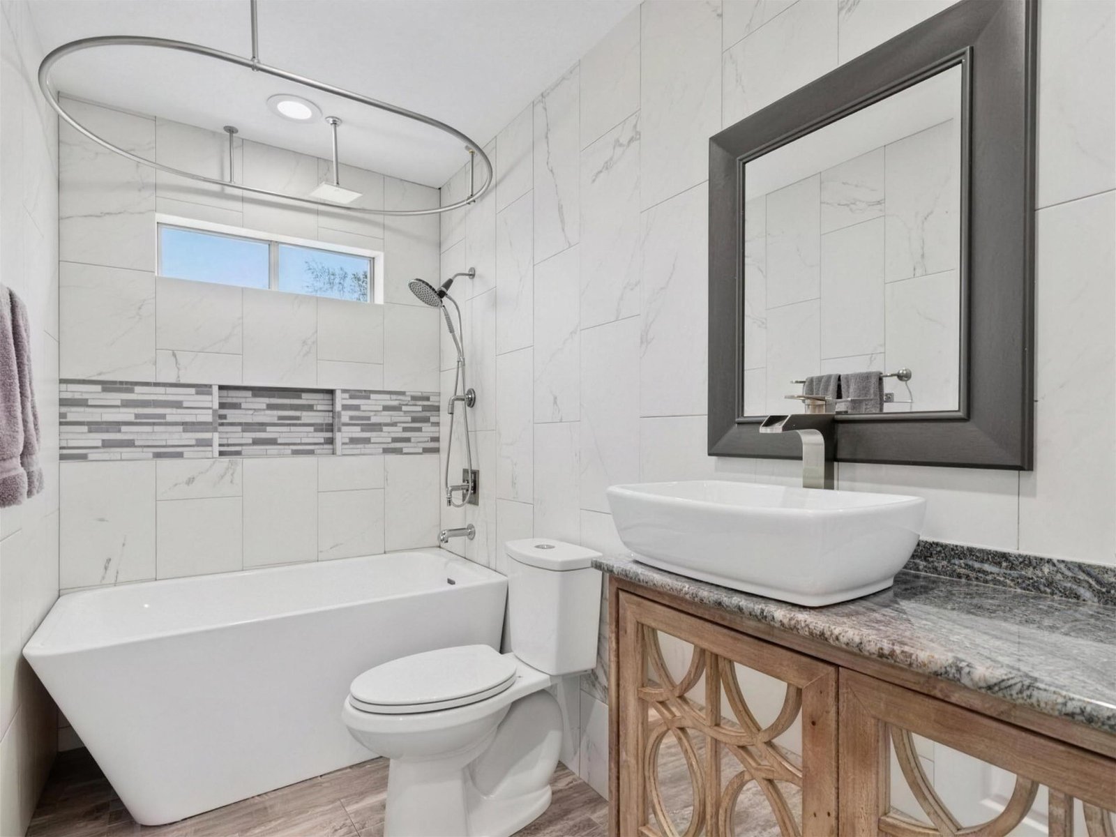 Bathroom remodel in Rowlett, TX — freestanding tub marble tile — UHS Remodeling project