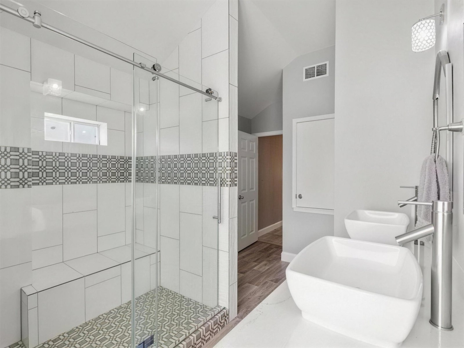 Bathroom remodel in Rowlett, TX — geometric mosaic shower — UHS Remodeling project