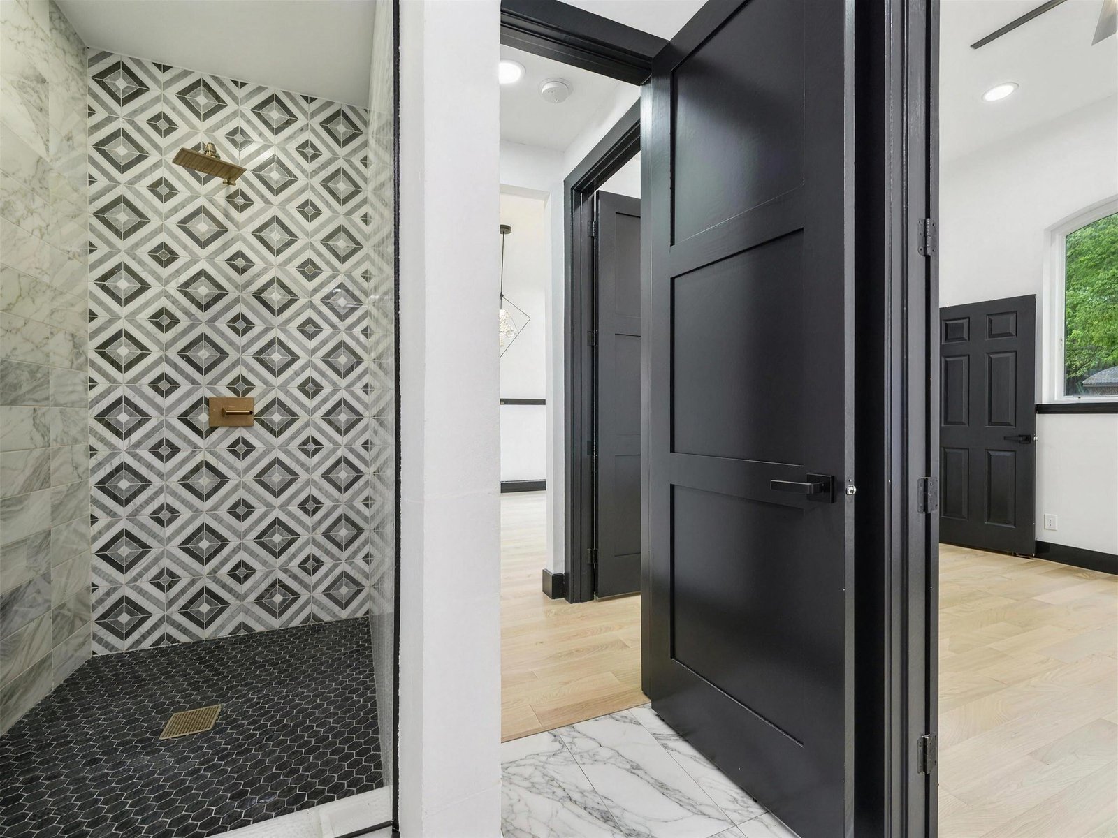 Bathroom remodel in Plano, TX — geometric tile shower brass — UHS Remodeling project