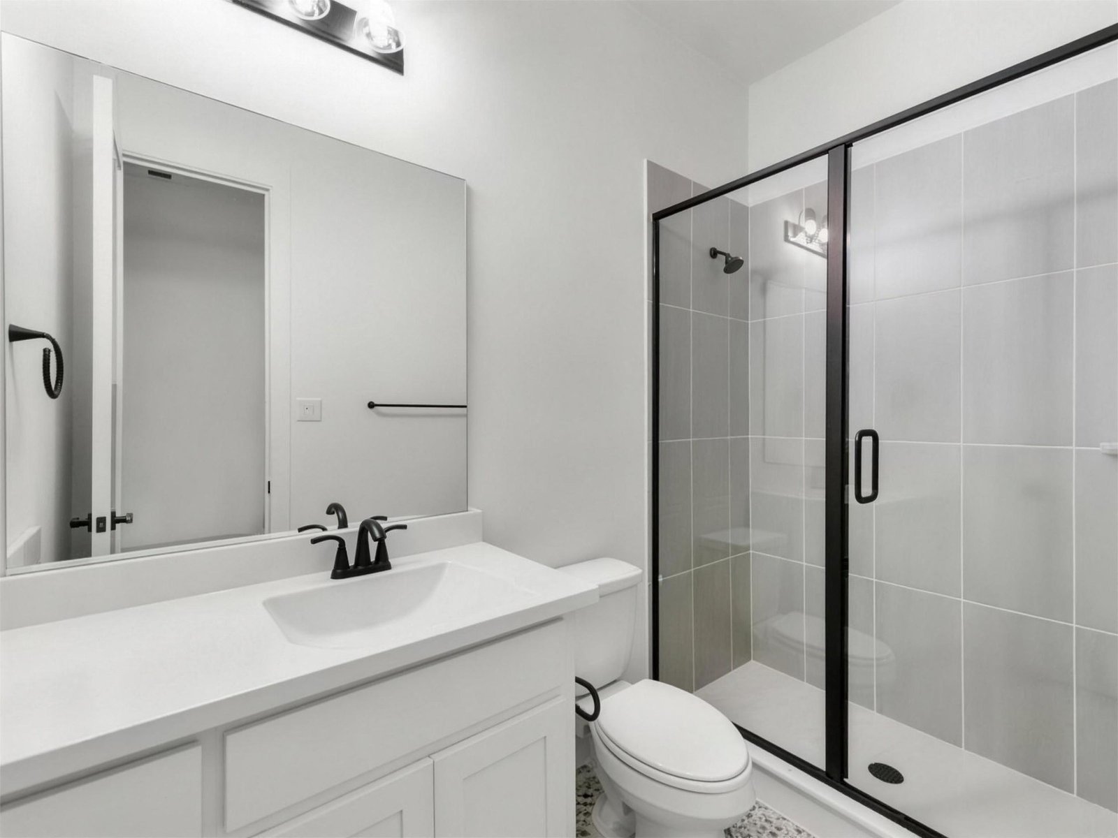 Bathroom remodel in Allen, TX — glass shower white vanity — UHS Remodeling project
