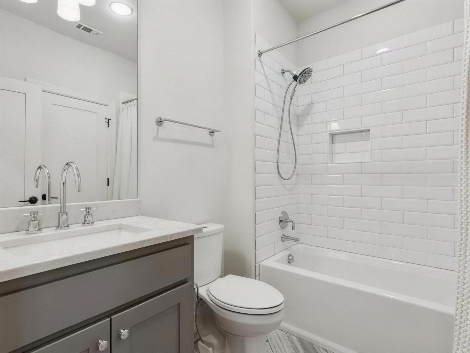 Bathroom remodel in University Park, TX — gray vanity subway tile — UHS Remodeling project