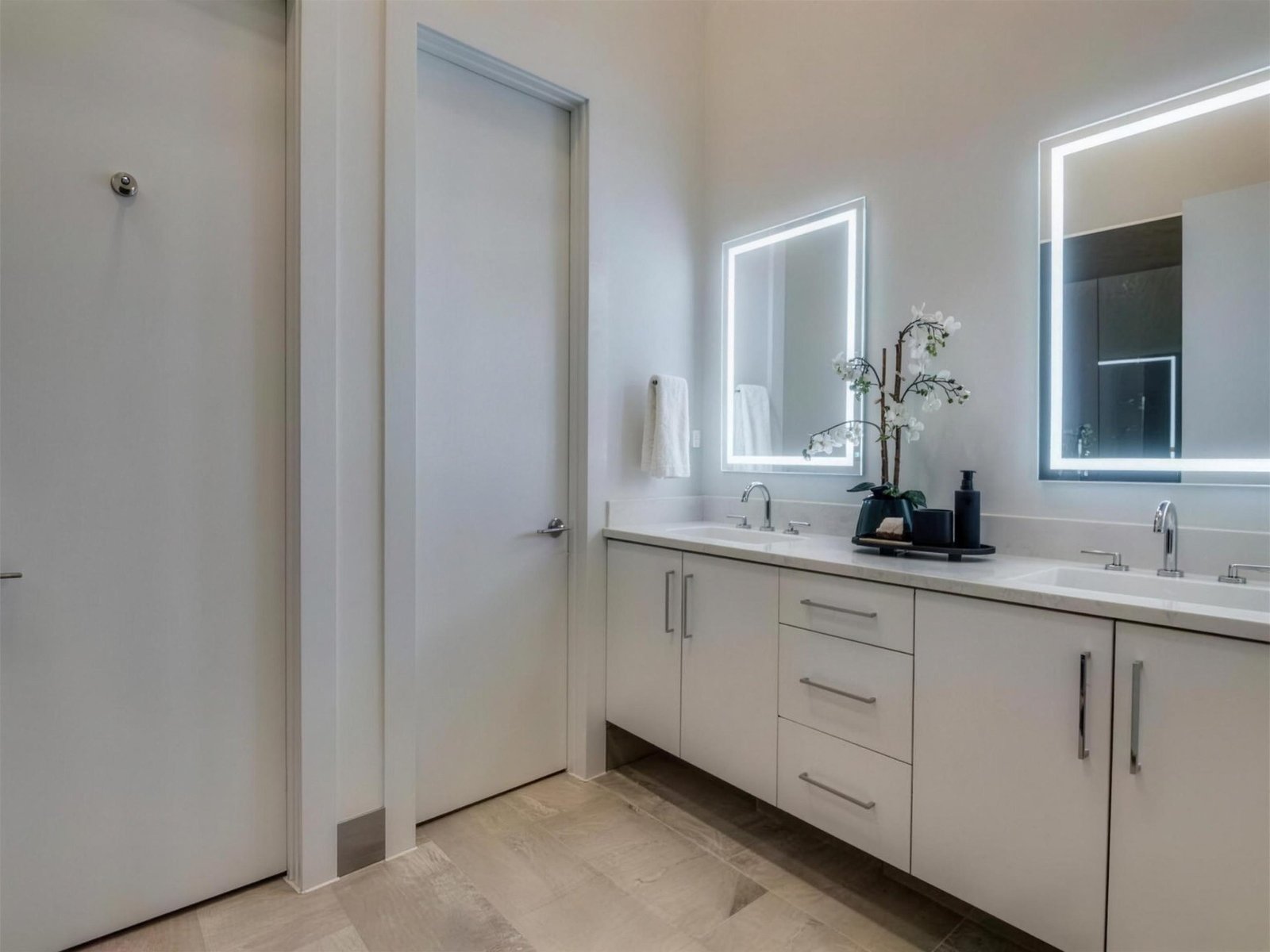 Bathroom remodel in Addison, TX — led mirror double vanity — UHS Remodeling project