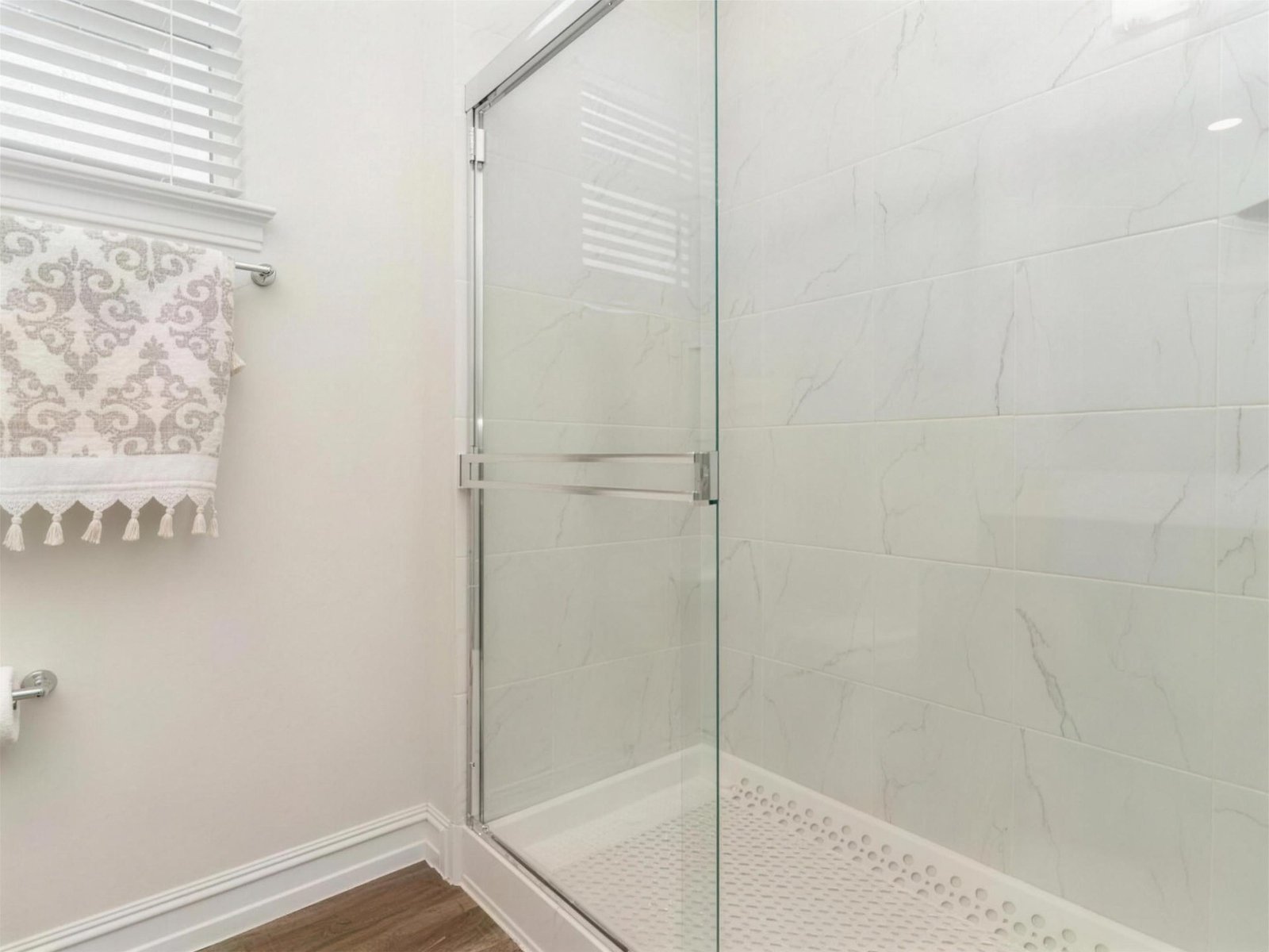 Bathroom remodel in Wylie, TX — marble tile glass shower — UHS Remodeling project
