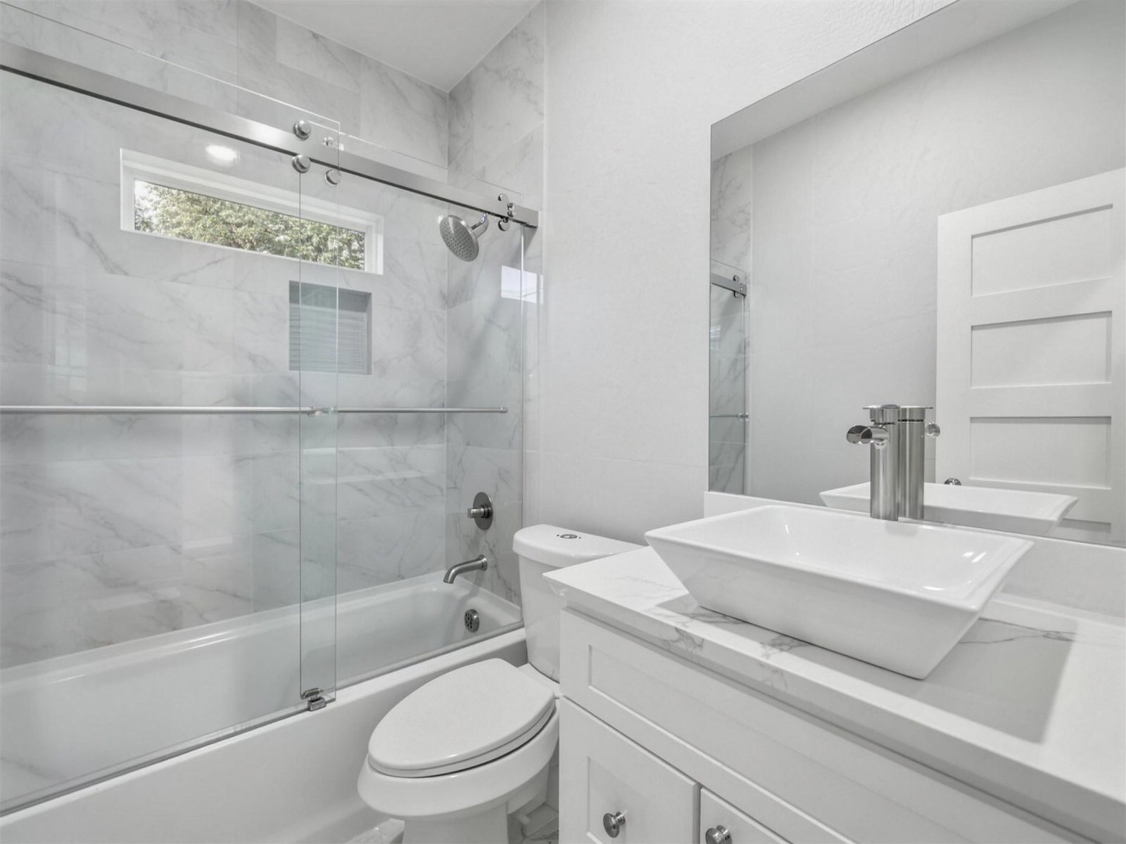 Bathroom remodel in Farmers Branch, TX — marble tub shower combo — UHS Remodeling project